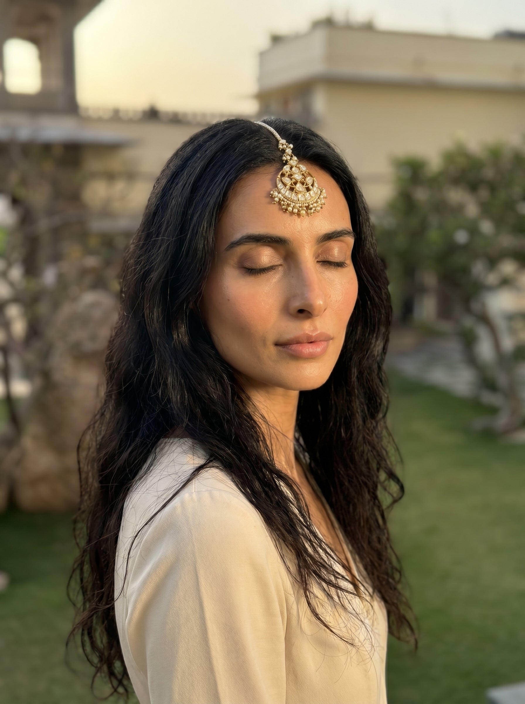 Woman with a traditional headpiece in an outdoor setting