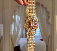 Jadau Kundan pearl choker with a four-strand pearl chain and ruby-kundan pendant
