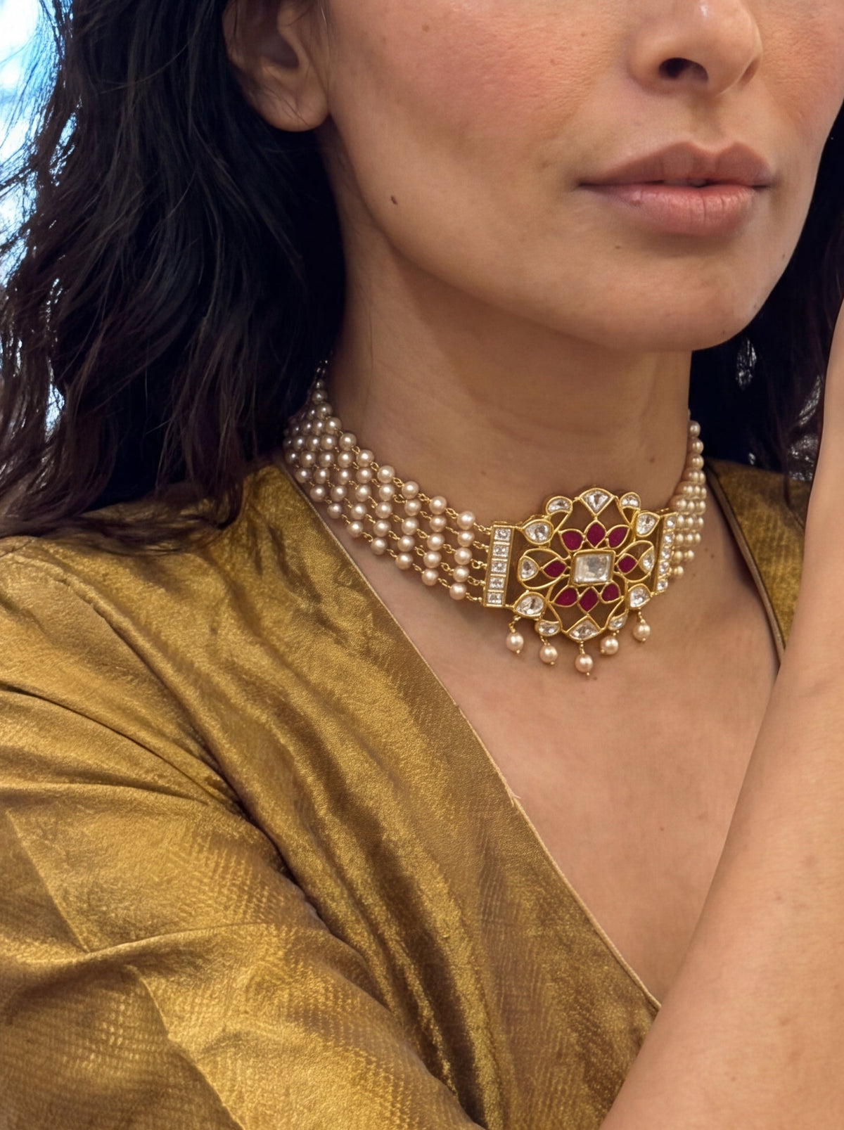 Jadau Kundan pearl choker with a four-strand pearl chain and ruby-kundan pendant
