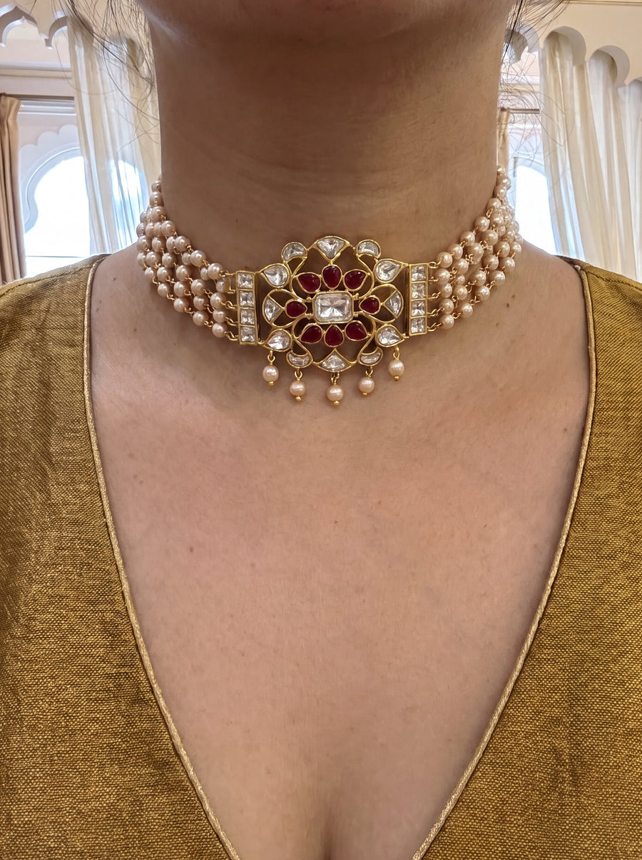 Jadau Kundan pearl choker with a four-strand pearl chain and ruby-kundan pendant