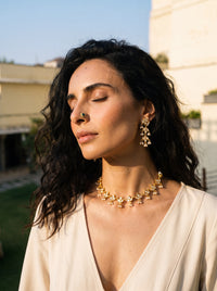 Jadau Kundan necklace with a leaf-motif vine and matching drop earrings