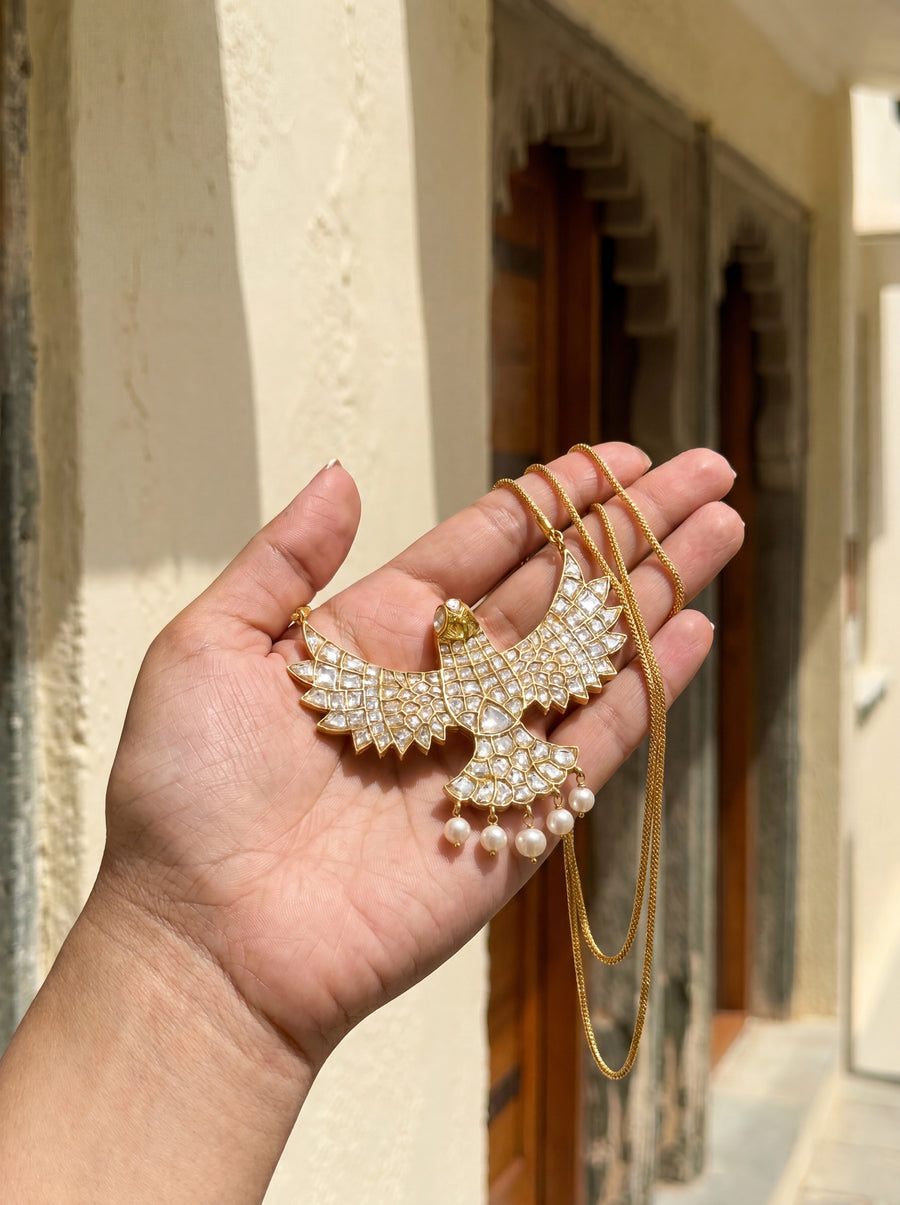 Kundan falcon pendant with full stone coverage and pearl-drop tail feathers