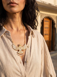 Kundan falcon pendant with full stone coverage and pearl-drop tail feathers