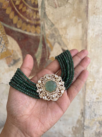 Multi-strand forest-green bead choker with a carved stone and CZ filigree pendant