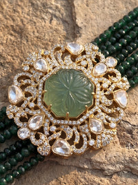 Multi-strand forest-green bead choker with a carved stone and CZ filigree pendant