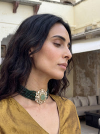 Multi-strand forest-green bead choker with a carved stone and CZ filigree pendant