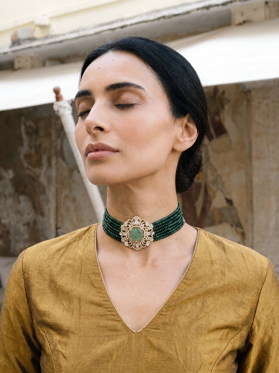 Multi-strand forest-green bead choker with a carved stone and CZ filigree pendant