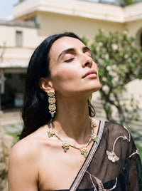 Jadau Kundan necklace set with lotus motifs, seed pearls, and jade beads