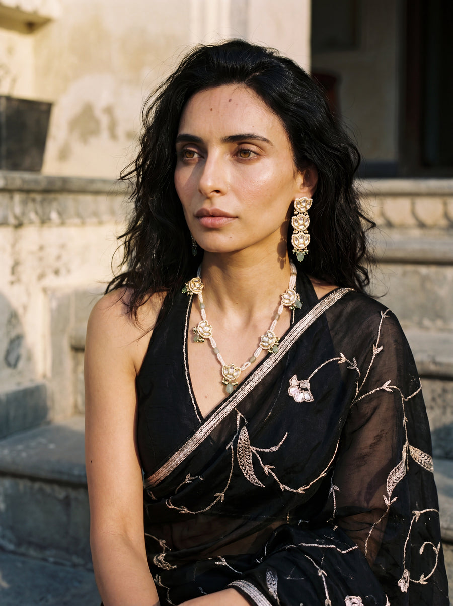 Jadau Kundan necklace set with lotus motifs, seed pearls, and jade beads