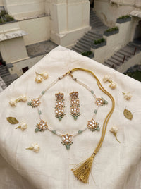 Jadau Kundan necklace set with lotus motifs, seed pearls, and jade beads