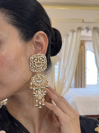 Kundan three-tier chandelier earrings with a mandala disc and pearl-emerald drops