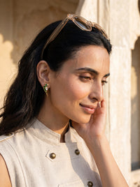 Jadau Kundan parrot stud earrings with vivid emerald detailing