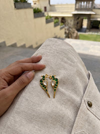 Jadau Kundan parrot stud earrings with vivid emerald detailing
