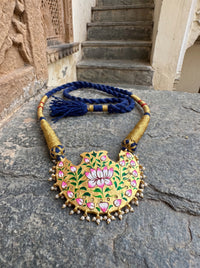 Blue meenakari wing pendant with Kundan border and pearl drops on a wrapped dori