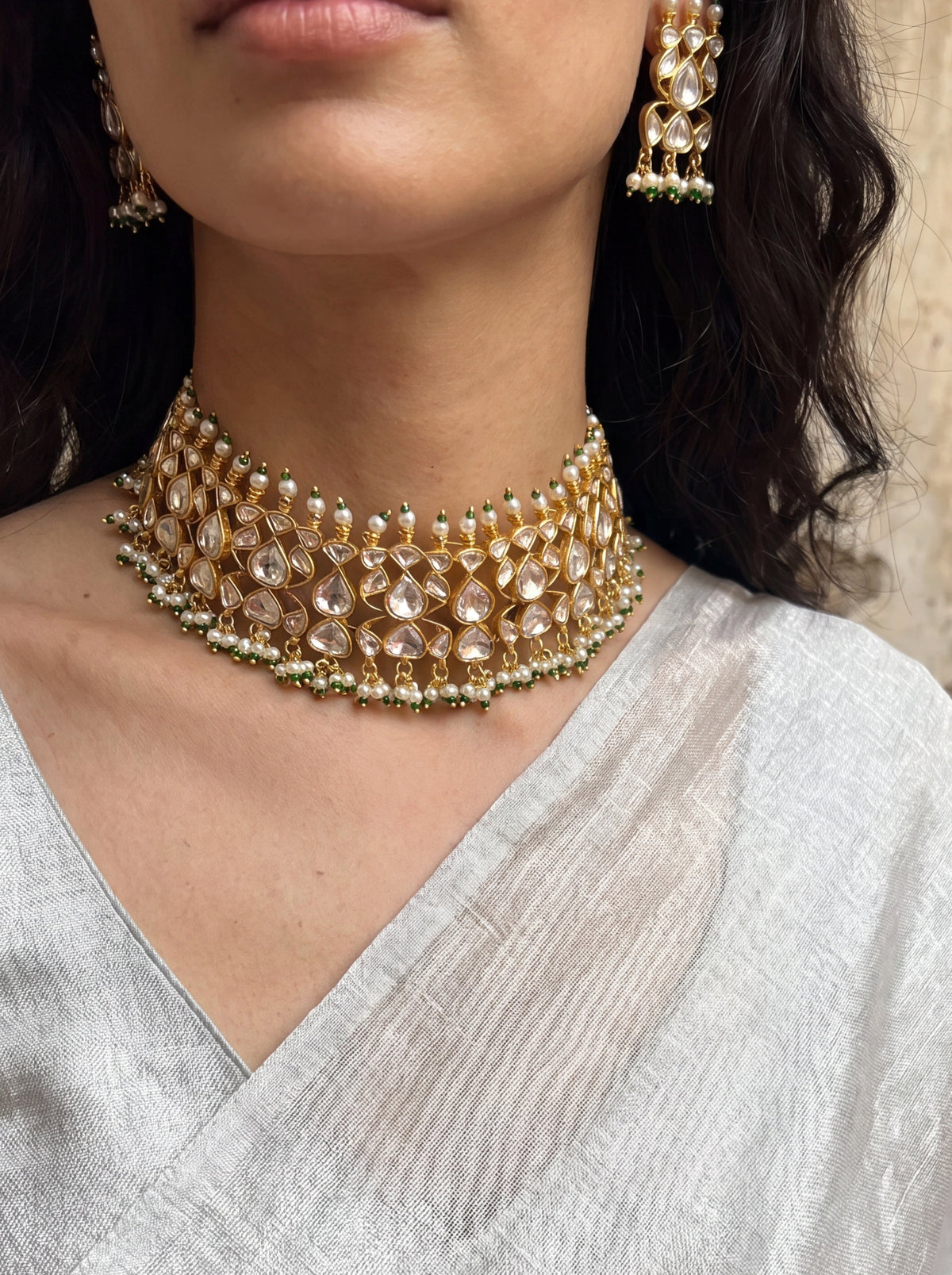 Jadau Kundan choker set with dense teardrop stones and matching earrings
