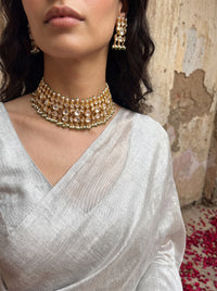 Jadau Kundan choker set with dense teardrop stones and matching earrings