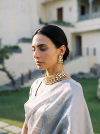 Jadau Kundan choker set with dense teardrop stones and matching earrings