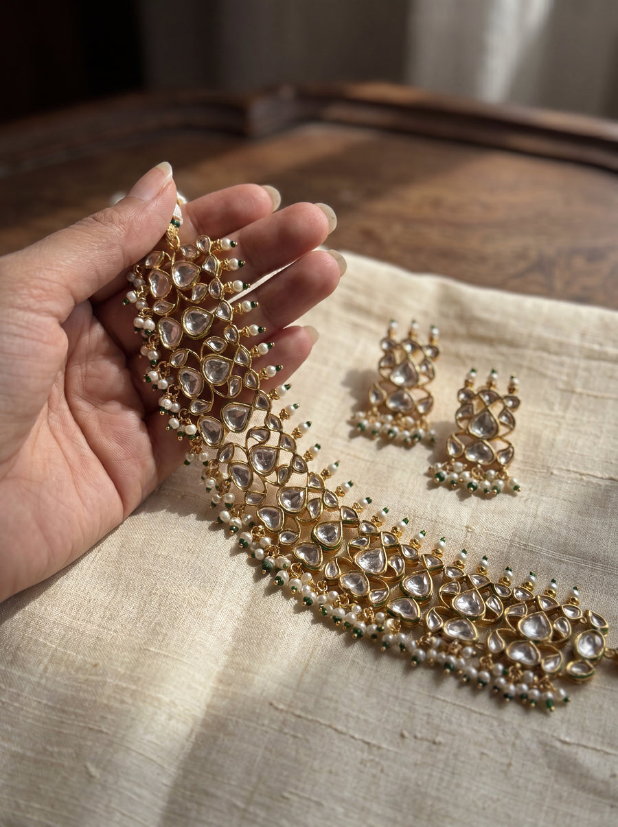 Jadau Kundan choker set with dense teardrop stones and matching earrings