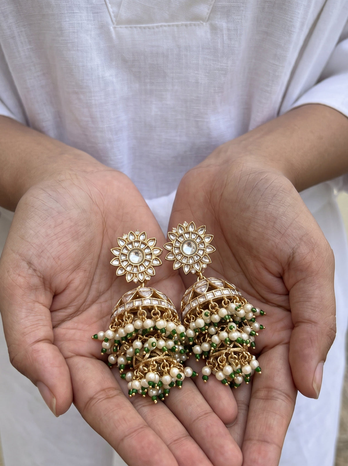 Jadau Kundan jhumka earrings with a dome body and triple-tier pearl fringe