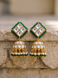 Kundan jhumka earrings with an emerald bead border and pearl-green fringe
