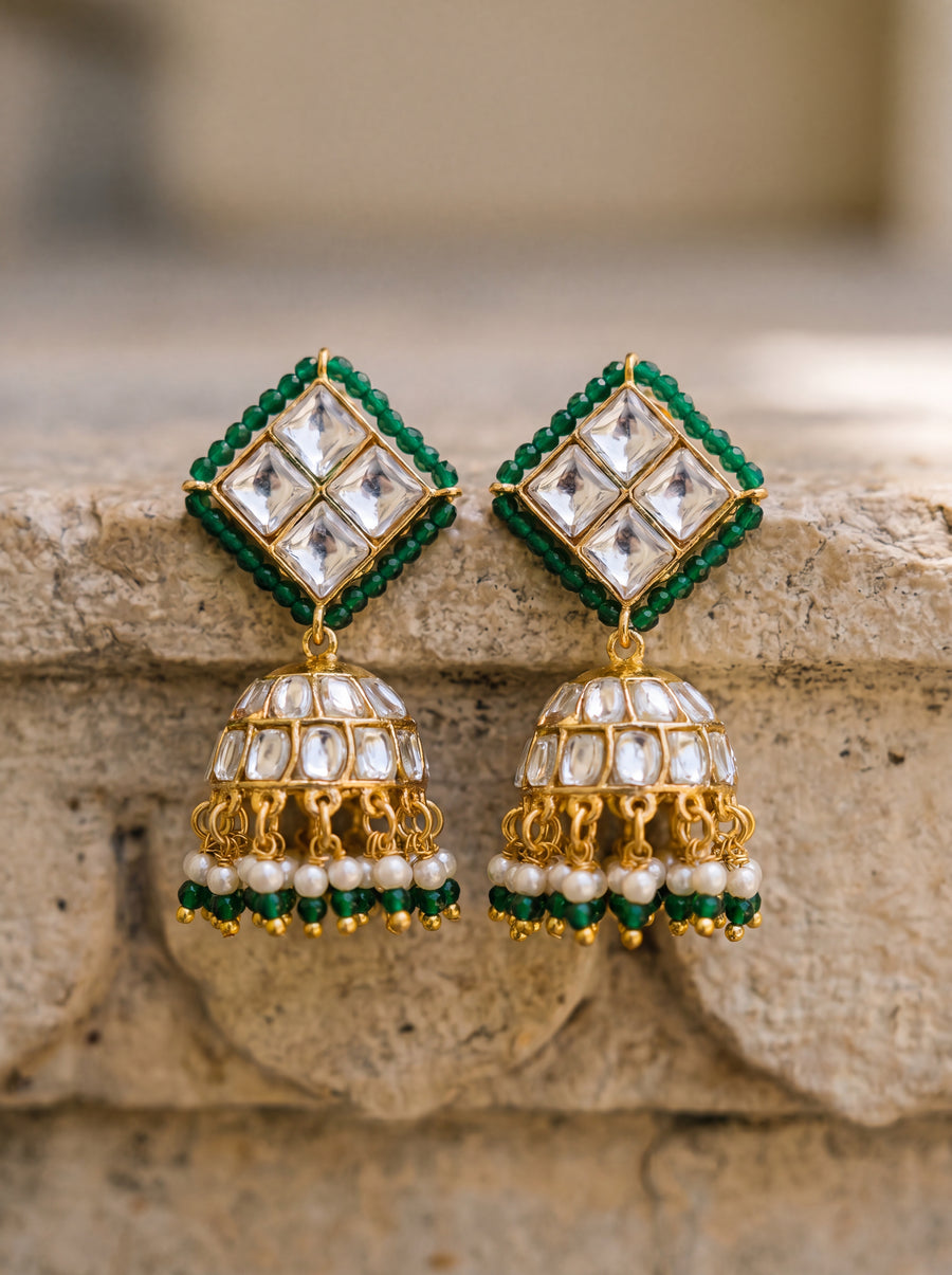 Kundan jhumka earrings with an emerald bead border and pearl-green fringe