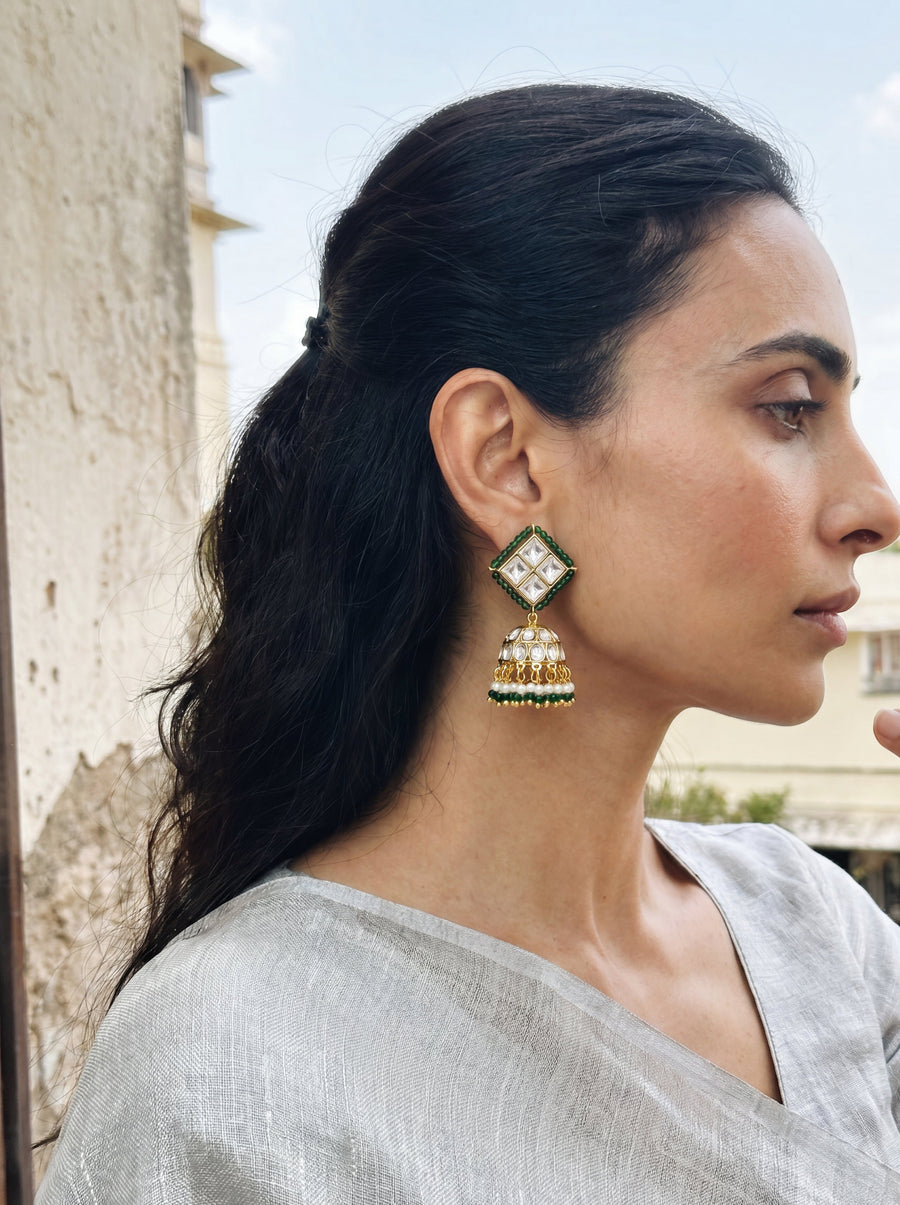 Kundan jhumka earrings with an emerald bead border and pearl-green fringe