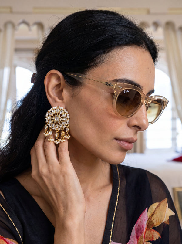 Gold-plated statement earrings with a turquoise floral cluster and pearl fringe
