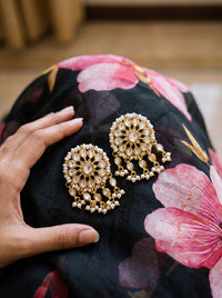 Gold-plated statement earrings with a turquoise floral cluster and pearl fringe