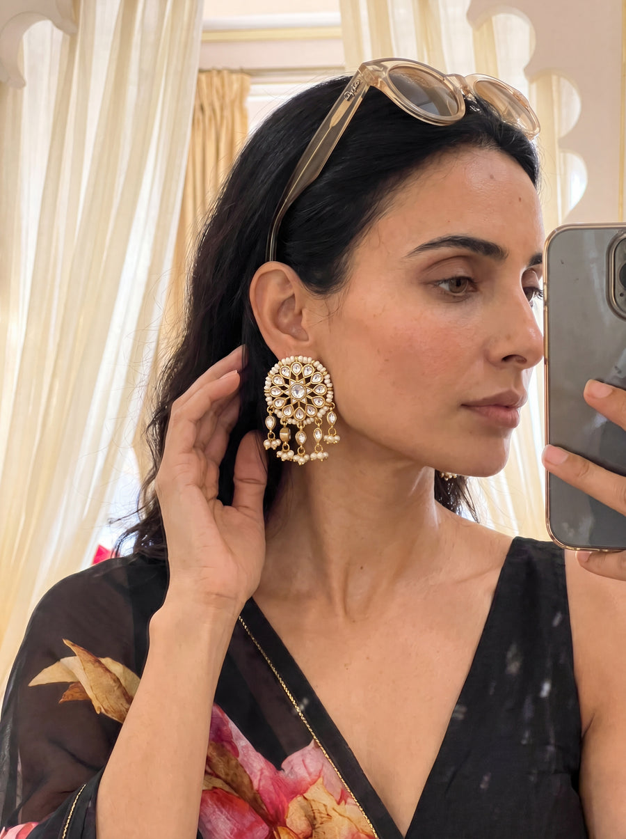 Gold-plated statement earrings with a turquoise floral cluster and pearl fringe
