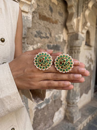 Jadau Kundan stud earrings with a layered emerald floral bloom and pearl border
