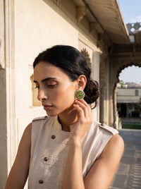 Jadau Kundan stud earrings with a layered emerald floral bloom and pearl border