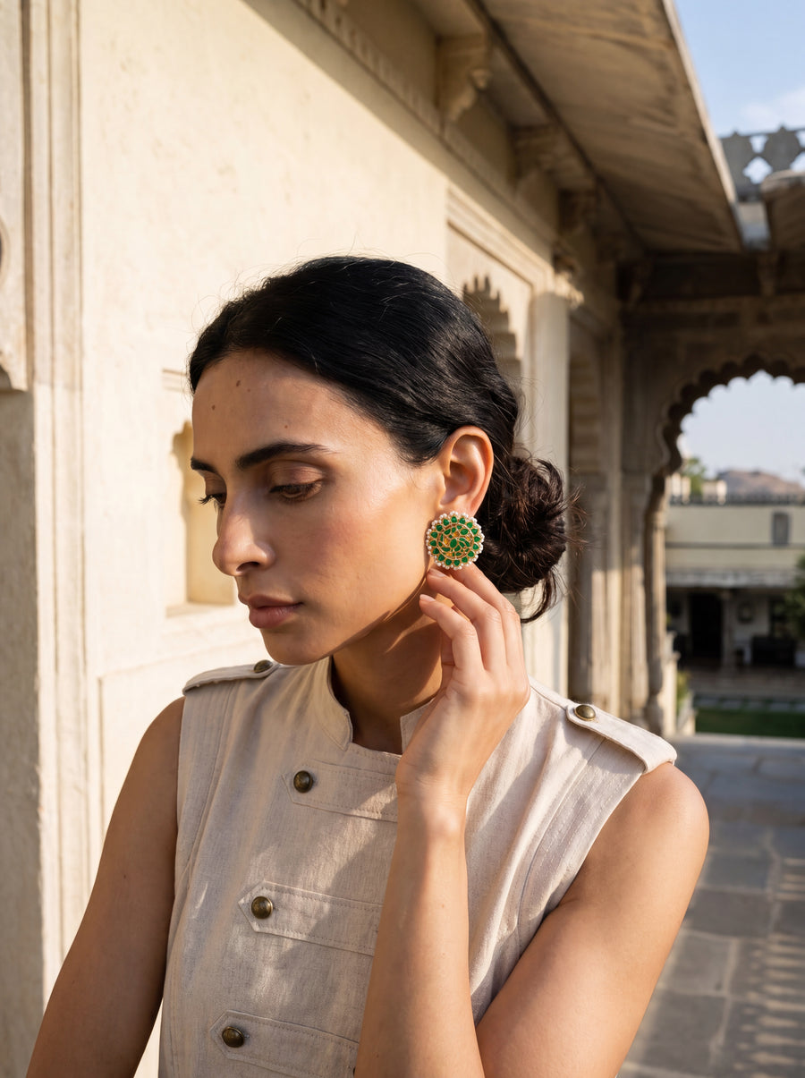 Jadau Kundan stud earrings with a layered emerald floral bloom and pearl border