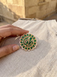 Jadau Kundan stud earrings with a layered emerald floral bloom and pearl border