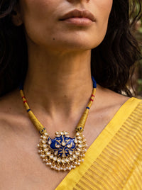 Blue meenakari wing pendant with Kundan border and pearl drops on a wrapped dori