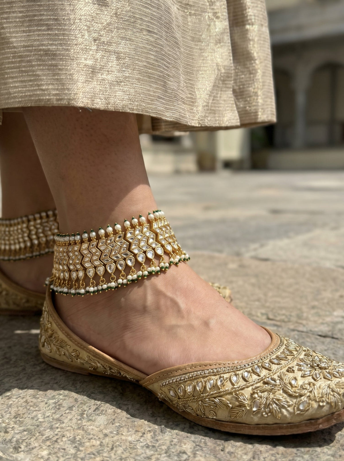 Handcrafted Jadau Kundan bridal anklets in gold-plated silver alloy with pearl and emerald bead drops