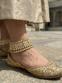 Handcrafted Jadau Kundan bridal anklets in gold-plated silver alloy with pearl and emerald bead drops