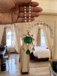Kundan pendant necklace with a carved emerald-green stone and pearl-jade chain