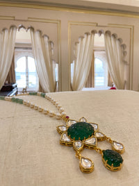Kundan pendant necklace with a carved emerald-green stone and pearl-jade chain