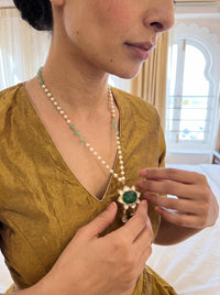 Kundan pendant necklace with a carved emerald-green stone and pearl-jade chain