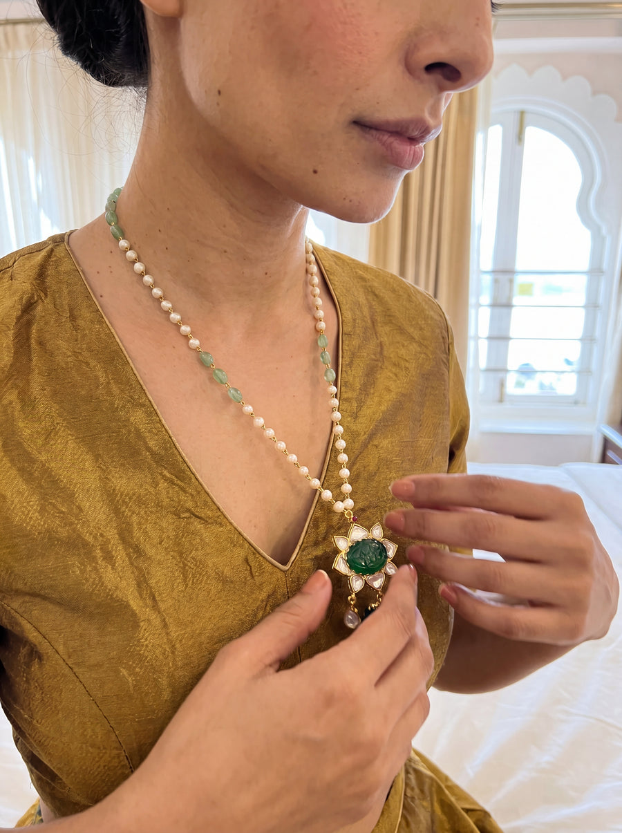 Kundan pendant necklace with a carved emerald-green stone and pearl-jade chain