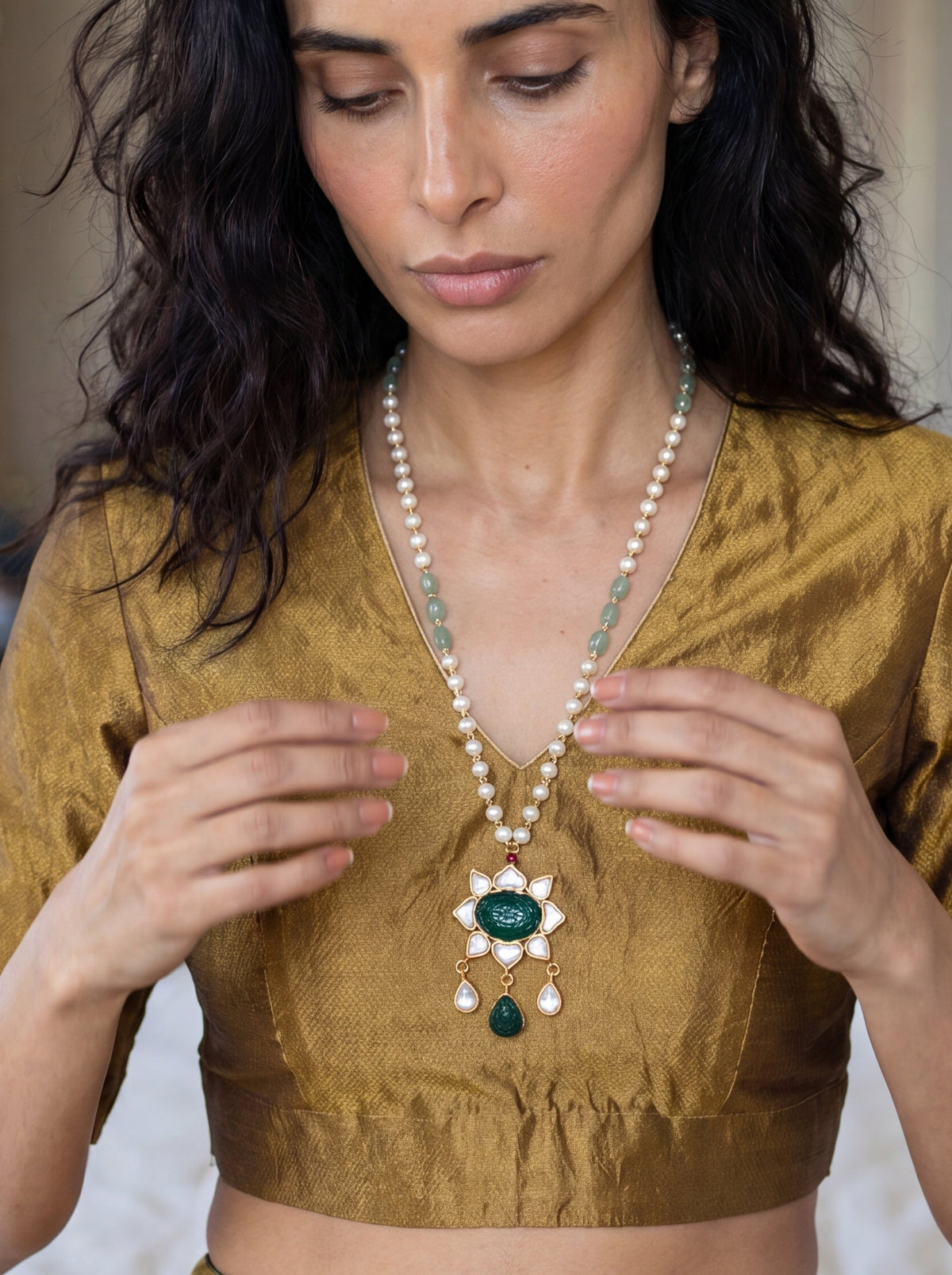 Kundan pendant necklace with a carved emerald-green stone and pearl-jade chain
