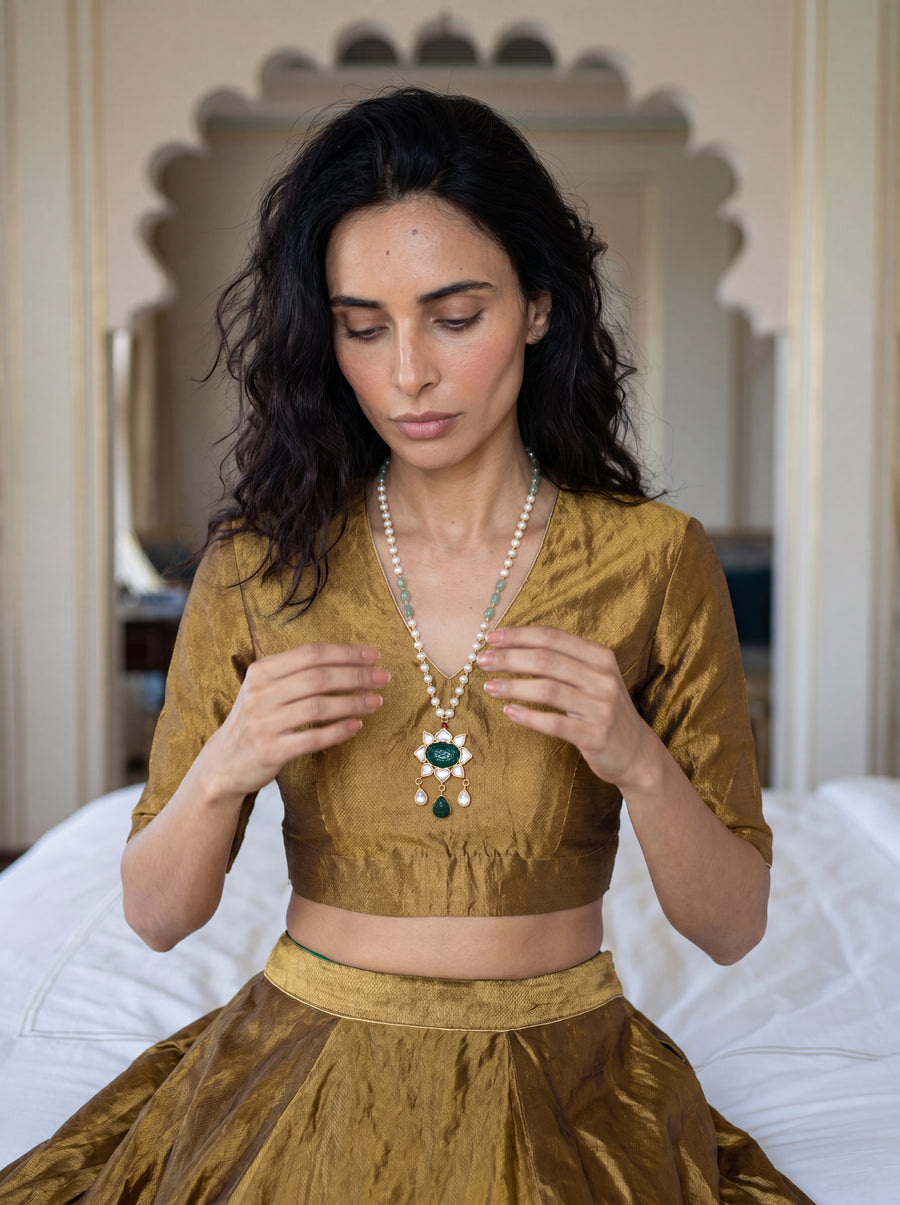 Kundan pendant necklace with a carved emerald-green stone and pearl-jade chain