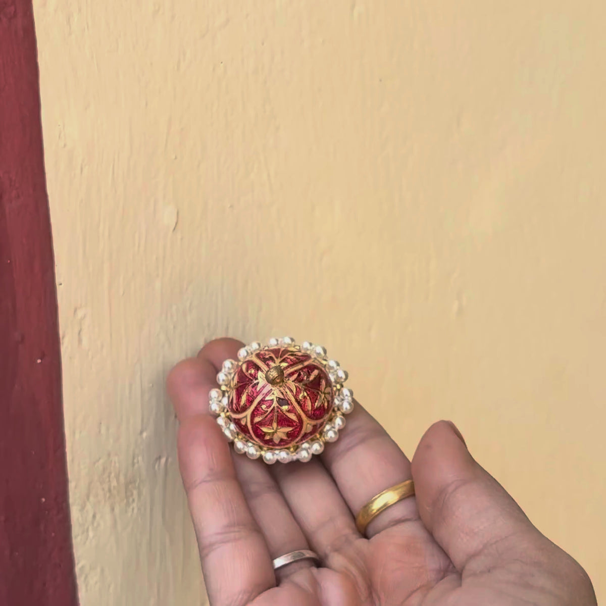 925 silver rakhdi with ruby meenakari petals and a sapphire kundan centre