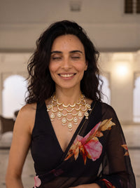 Kundan Polki bib necklace with cascading wave motifs and pearl drop clusters