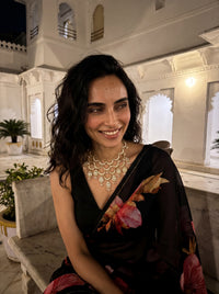Kundan Polki bib necklace with cascading wave motifs and pearl drop clusters
