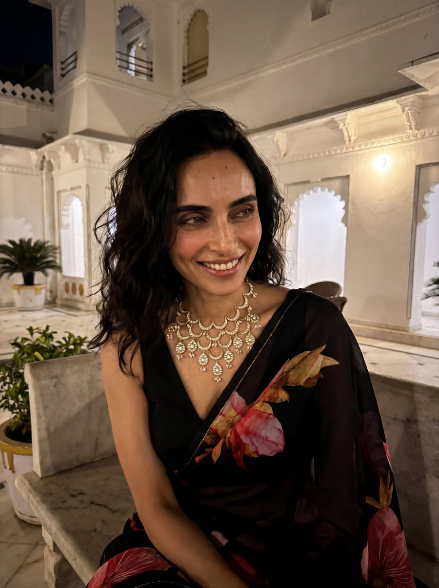 Kundan Polki bib necklace with cascading wave motifs and pearl drop clusters