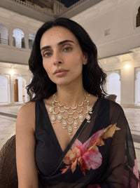 Kundan Polki bib necklace with cascading wave motifs and pearl drop clusters
