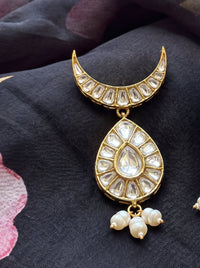 Kundan earrings with a crescent stud, teardrop centre, and trio pearl drops