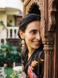 Kundan earrings with a crescent stud, teardrop centre, and trio pearl drops