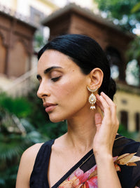 Kundan earrings with a crescent stud, teardrop centre, and trio pearl drops